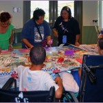 Hui Malama Po`o Shriner's Service Project. Photo of children learning how to make cards.