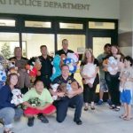 Photo of AILH and volunteers dropping off stuffed animals at HPD
