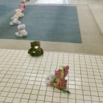 Photo of stuffed animals lined up going out of the building