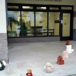 Photo of stuffed animals lined up going into the police station