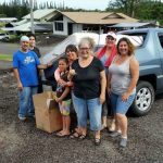 Photo of Lorna receiving her new bed and household goods