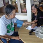 Photo of Lenora and Val Doing Blood Pressure Checks