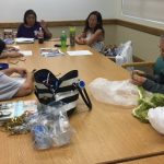 Photo of 5 ladies gathered around a conference table