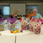Photo of Women's support group sitting around a conference table with easter baskets in the foreground