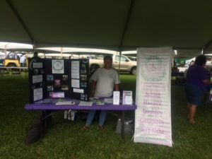 Photo of Lani standing behind display table