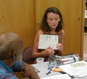 Photo of Kathleen showing Qcode and tactile