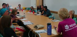 Photo of Hui Malama Po`o group seated around a conference table