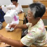 Photo of female using sewing machine