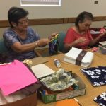 Photo of LivZen members working on sewing projects