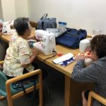 Photo of LivZen members working on sewing projects