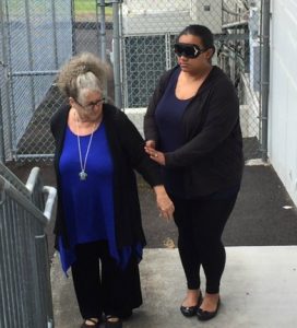 Photo of Emily guiding Lupe upstairs