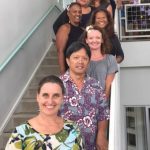 Photo of entire staff standing on stairwell during Staff Training in Hilo