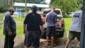 Photo of Lions club members loading furniture into truck