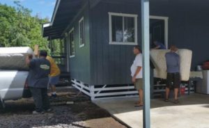 Photo of Lions club members moving furniture