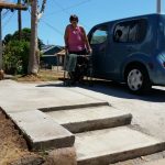 Photo of Missy standing near her car