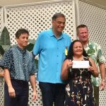 Photo of Roxanne receiving check from Oahu Charity Walk