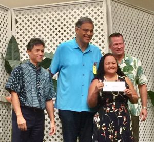 Photo of Roxanne receiving check from Oahu Charity Walk