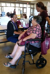 Photo of Julie speaking with fair attendees