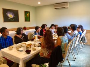 Photo of group seated around lunch table