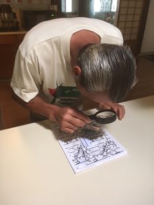 Photo of Anthony using magnifying glass