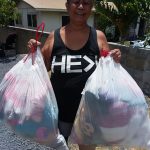 Photo of woman holding two bags full of stuffed animals