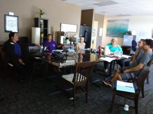 Photo of Maui Support Group Members gathered around a conference table