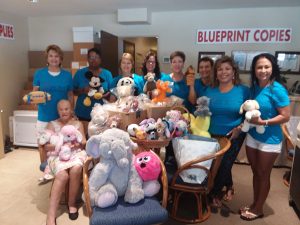 Photo of Maria Terra and the West Maui Task Force with stuffed animals