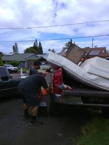 Photo of men unloading items from truck