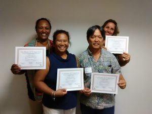 Photo of Julie, Lani, Tom, and Karin holding certificates