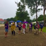 Photo of Kathleen leading participants on white cane walk