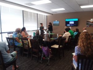 Photo of group listening to Raina's presentation