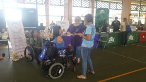 Photo of Emily talking to folks at Hilo Housing Fair