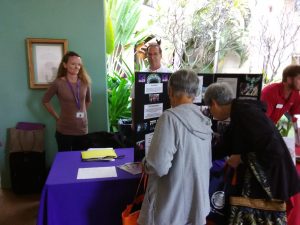 Photo of Kathleen and Brian standing next to AILH booth