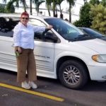 Photo of Sam standing next to donated van