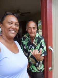 Photo of Julie and Avard standing at doorway of his new home