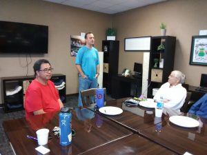 Photo of Ted Anderson standing and talking to group