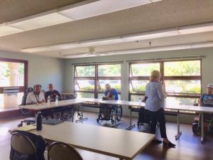 Photo of Dora speaking to residents of Hale Kuhao