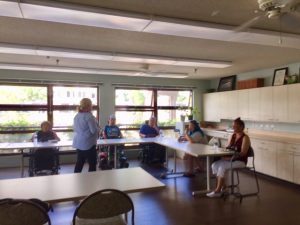 Photo of Dora speaking to residents of Hale Kuhao