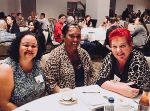 Photo of Roxanne, Julie, and Sam sitting at LGBQT conference