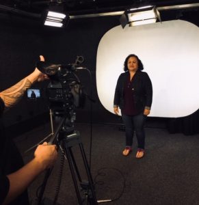 Roxanne standing in front of camera at Olelo PSA filming